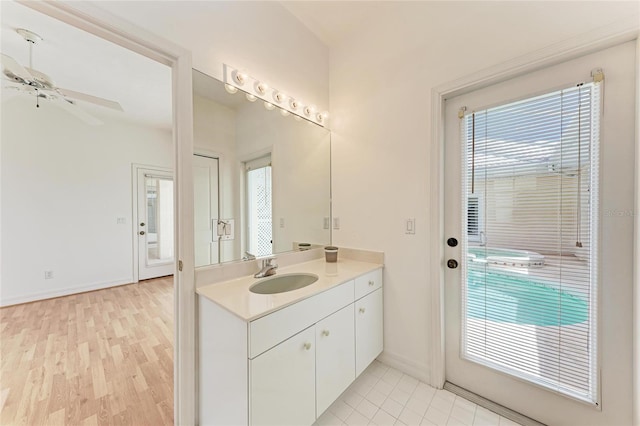585 Khyber Ln, Venice, FL 34293 - bathroom with ceiling fan, vanity, baseboards, and wood finished floors