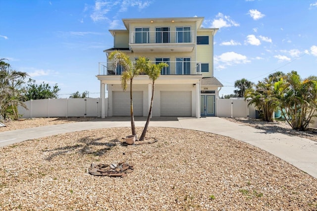 4717 Lemon Bay Dr, Venice, FL 34293 - raised beach house with a garage, fence, a balcony, a gate, and concrete driveway