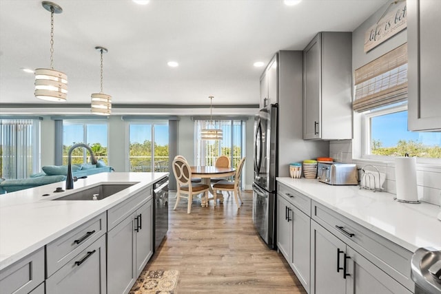 4717 Lemon Bay Dr, Venice, FL 34293 - kitchen with appliances with stainless steel finishes, a sink, gray cabinetry, recessed lighting, and light wood-style flooring