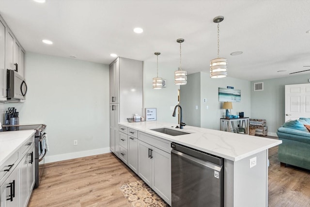 4717 Lemon Bay Dr, Venice, FL 34293 - kitchen with visible vents, a sink, a peninsula, open floor plan, and stainless steel appliances