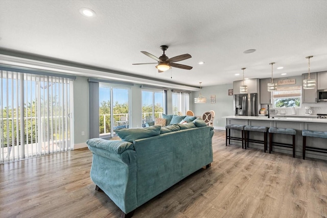 4717 Lemon Bay Dr, Venice, FL 34293 - living area with wood finished floors, baseboards, ceiling fan, recessed lighting, and a textured ceiling