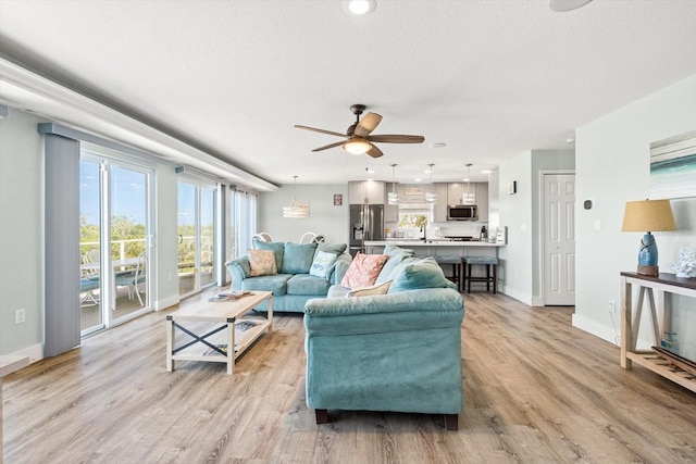 4717 Lemon Bay Dr, Venice, FL 34293 - living room featuring light wood-style floors, baseboards, a ceiling fan, and recessed lighting