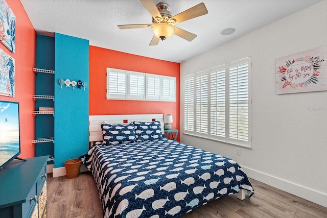 4717 Lemon Bay Dr, Venice, FL 34293 - bedroom with baseboards, a ceiling fan, and wood finished floors