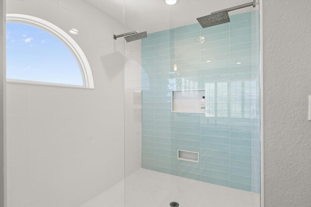 4717 Lemon Bay Dr, Venice, FL 34293 - full bathroom with a textured wall and a tile shower