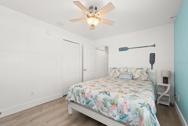 4717 Lemon Bay Dr, Venice, FL 34293 - bedroom with baseboards, ceiling fan, and wood finished floors