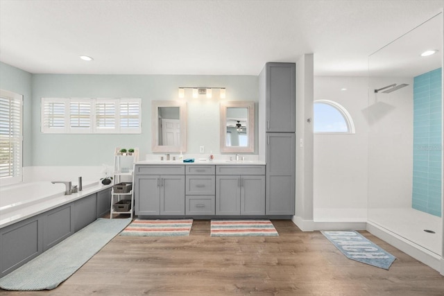 4717 Lemon Bay Dr, Venice, FL 34293 - bathroom with a sink, a tile shower, and wood finished floors