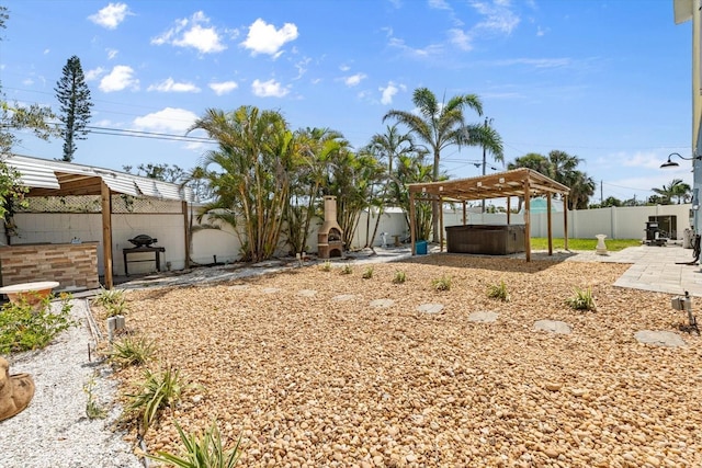 4717 Lemon Bay Dr, Venice, FL 34293 - view of yard featuring a fenced backyard, a hot tub, and a patio area
