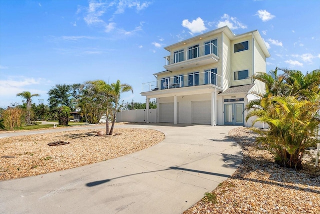 4717 Lemon Bay Dr, Venice, FL 34293 - raised beach house featuring a garage, fence, driveway, and a balcony