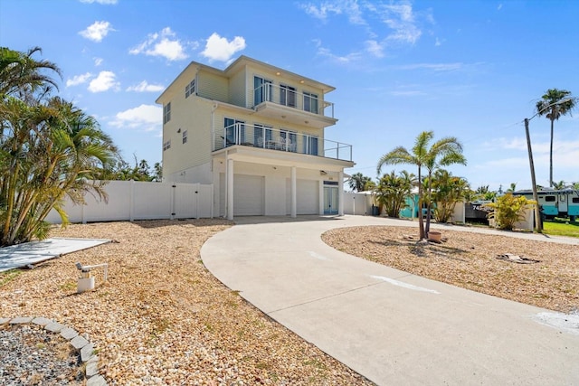 4717 Lemon Bay Dr, Venice, FL 34293 - beach home featuring a gate, a garage, fence, a balcony, and concrete driveway