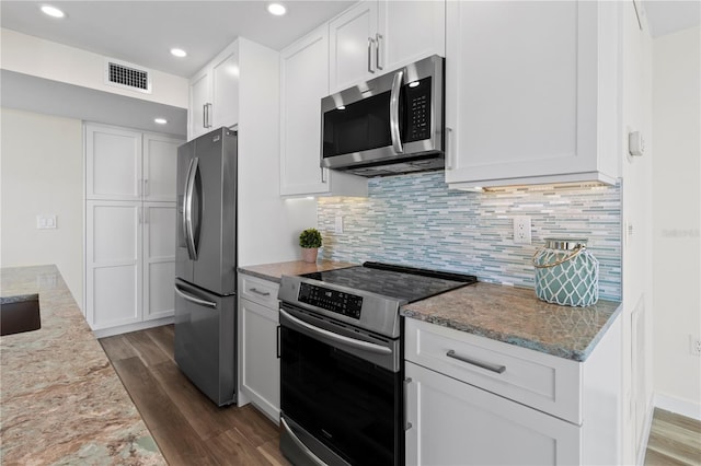 kitchen featuring white cabinetry, light stone countertops, appliances with stainless steel finishes, and dark wood-style floors
