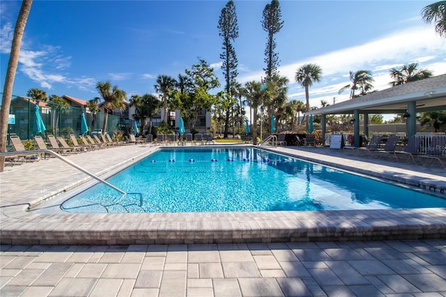 pool with fence and a patio area