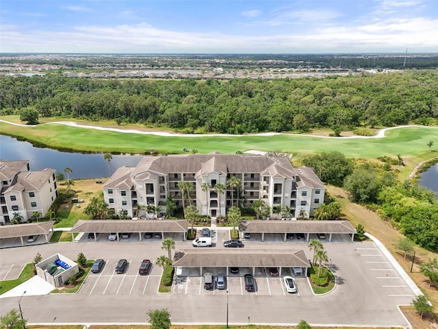 aerial view of a large body of water, a local golf course, and apartment complex / building
