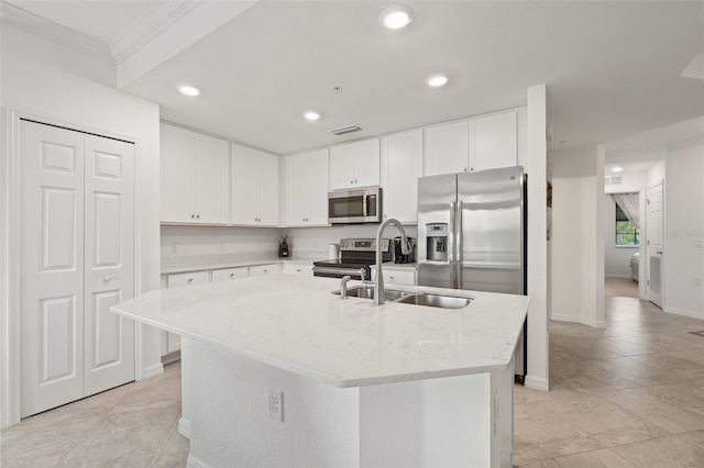 kitchen featuring stainless steel appliances, a sink, a center island with sink, recessed lighting, and light stone countertops