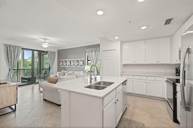 kitchen featuring a sink, stainless steel appliances, ceiling fan, open floor plan, and crown molding