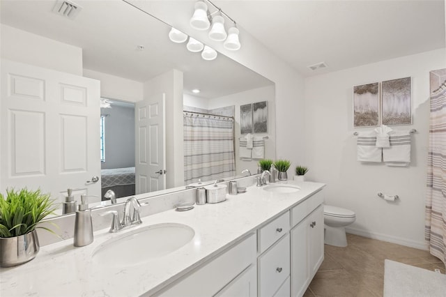 full bath featuring toilet, tile patterned floors, double vanity, baseboards, and curtained shower