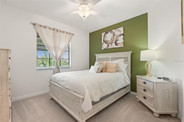 bedroom with light carpet, baseboards, and ceiling fan