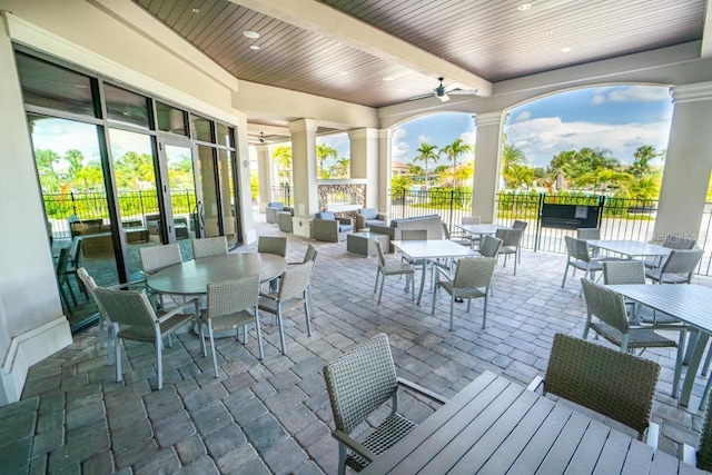 view of patio with outdoor dining area, outdoor lounge area, fence, and ceiling fan