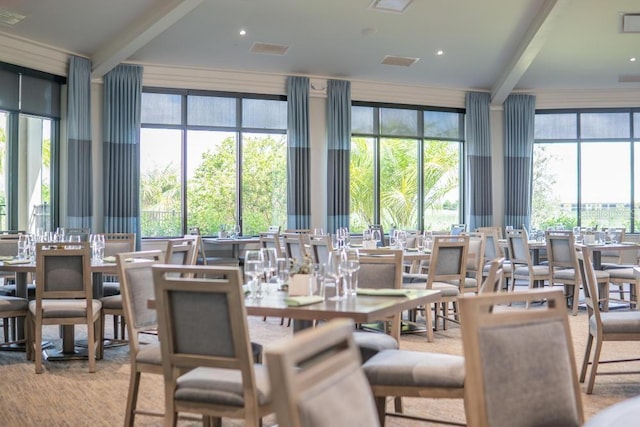dining space with beam ceiling