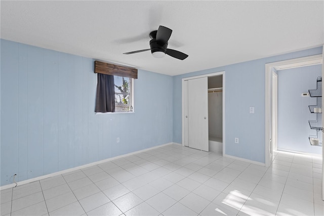1802 Robinhood St, Sarasota, FL 34231 - unfurnished bedroom featuring baseboards, ceiling fan, tile patterned flooring, and a closet