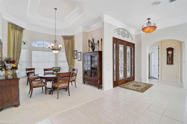 2111 Muskogee Trl, Nokomis, FL 34275 - foyer featuring arched walkways, a notable chandelier, ornamental molding, and light tile patterned flooring