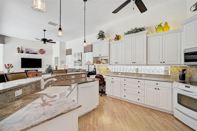 2111 Muskogee Trl, Nokomis, FL 34275 - kitchen with a sink, white cabinetry, ceiling fan, and white appliances