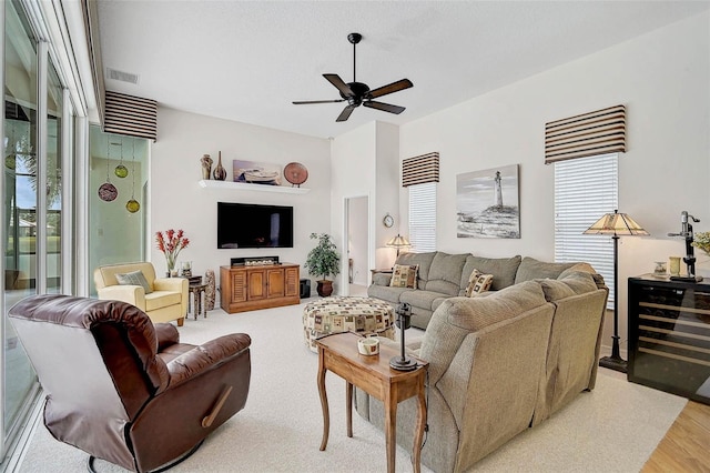 2111 Muskogee Trl, Nokomis, FL 34275 - living room featuring a ceiling fan, visible vents, and light wood-style flooring
