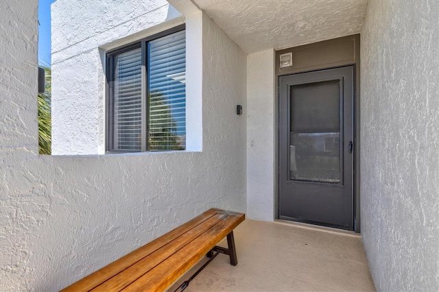 entrance to property featuring stucco siding