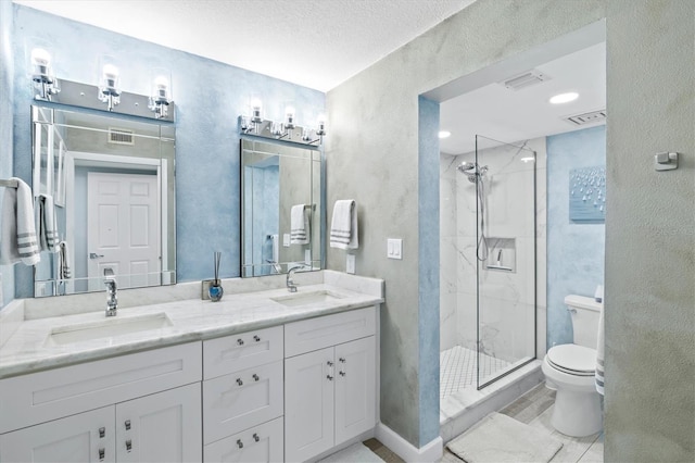 bathroom featuring a textured wall, toilet, and a sink