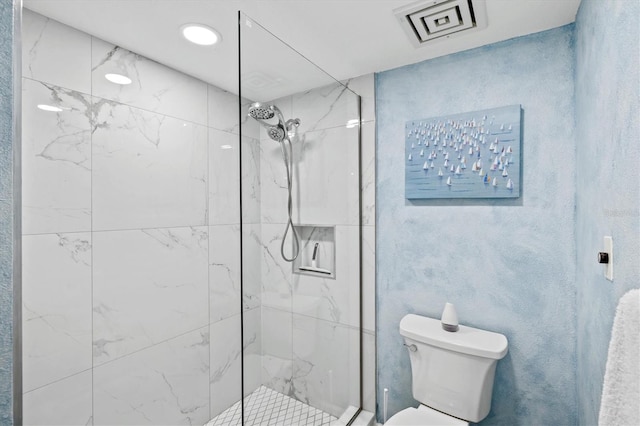 bathroom featuring toilet, visible vents, and a marble finish shower