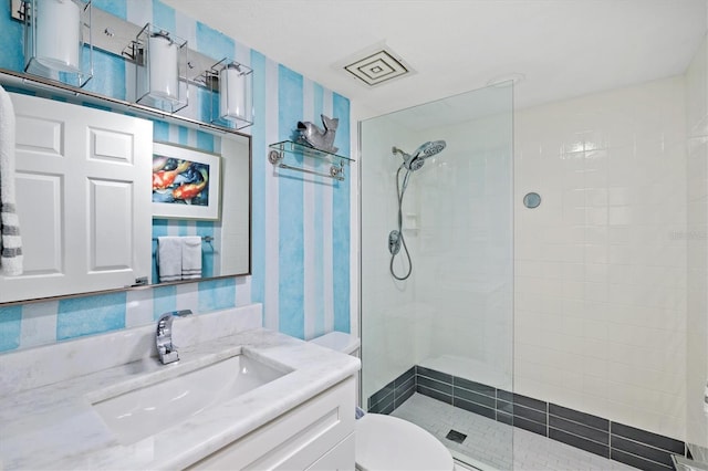 full bath with toilet, vanity, and a walk in shower