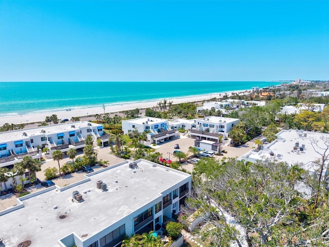 bird's eye view featuring a water view and a beach view