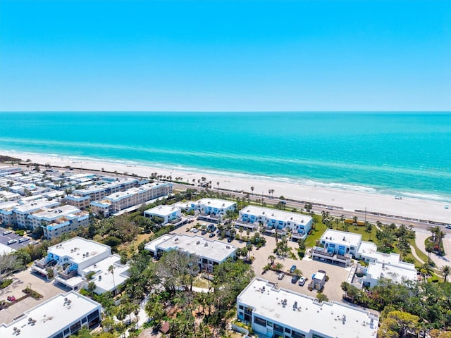 aerial view with a water view and a beach view