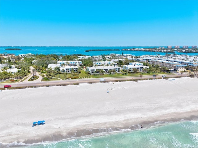 bird's eye view featuring a water view and a view of the beach
