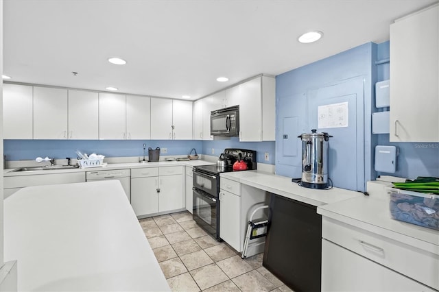 kitchen featuring a sink, white cabinetry, black appliances, light countertops, and recessed lighting
