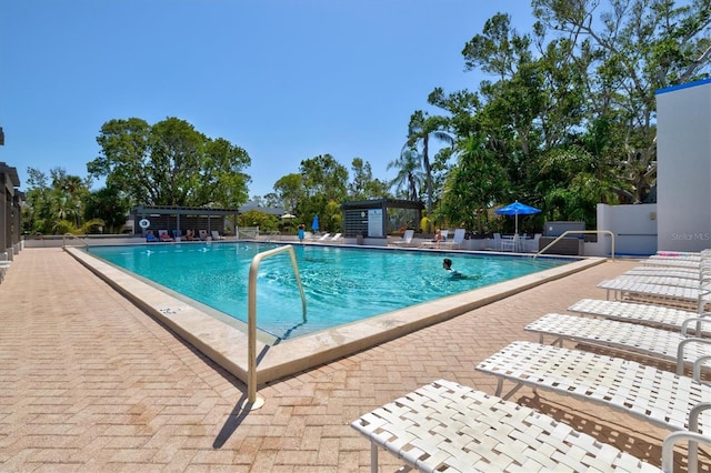 pool featuring fence and a patio