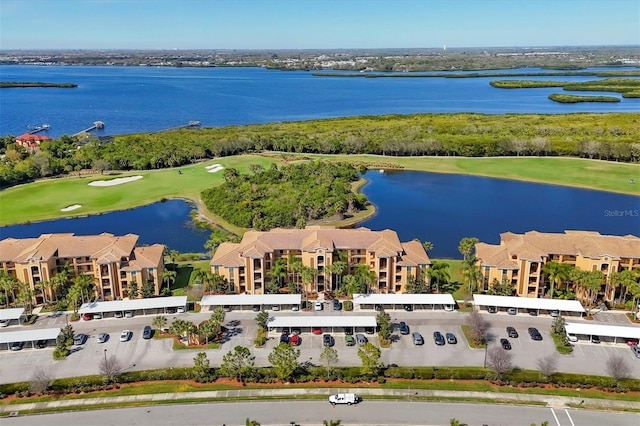 birds eye view of property featuring view of golf course and a water view