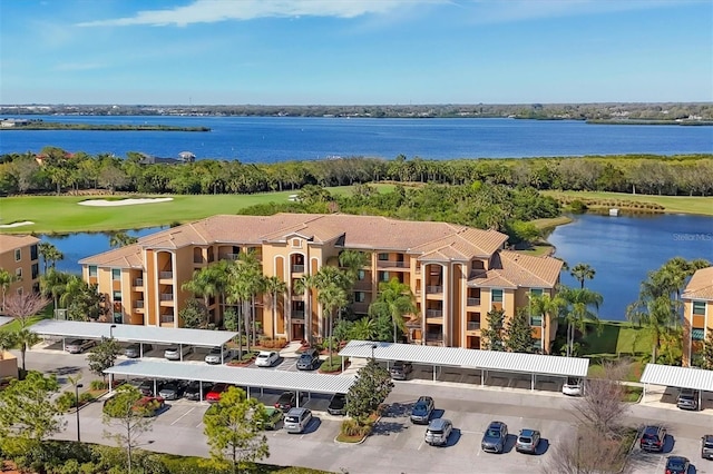 birds eye view of property featuring view of golf course and a water view