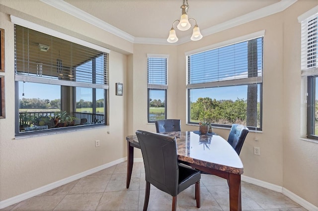 dining room featuring tile patterned flooring, ornamental molding, baseboards, and an inviting chandelier