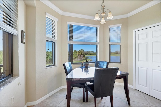 dining room featuring ornamental molding, light tile patterned flooring, a notable chandelier, and baseboards