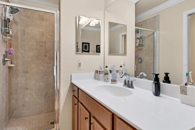 bathroom with vanity, a shower stall, and ornamental molding