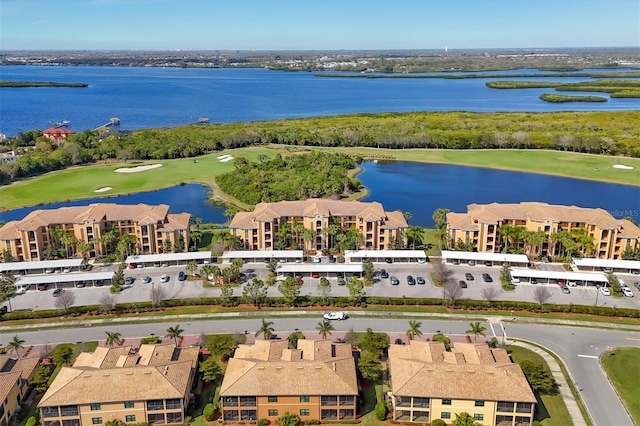 birds eye view of property featuring view of golf course and a water view