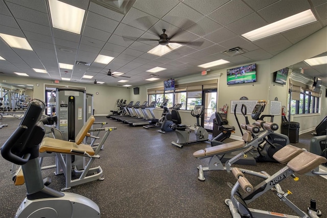 gym with visible vents, baseboards, a ceiling fan, and a paneled ceiling