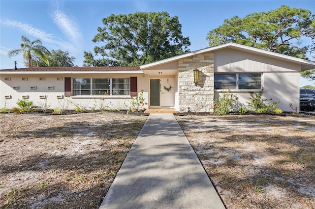 single story home featuring stone siding