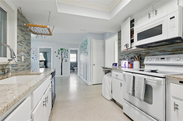 kitchen featuring a sink, tasteful backsplash, light speckled floor, and white appliances