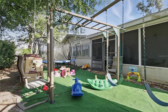 view of jungle gym with a trampoline