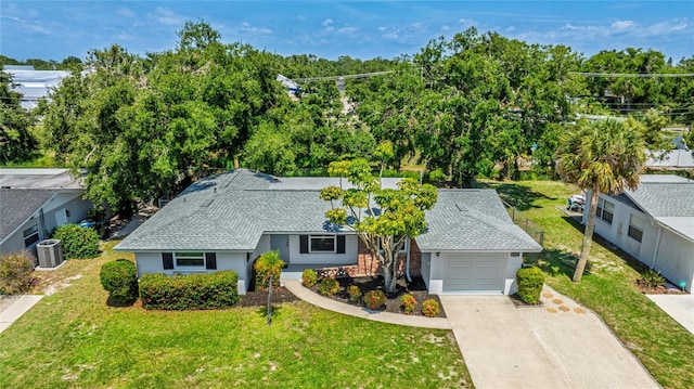 6529 Seagate Ave, Sarasota, FL 34231 - view of front of house with a garage, central AC unit, driveway, and a front yard
