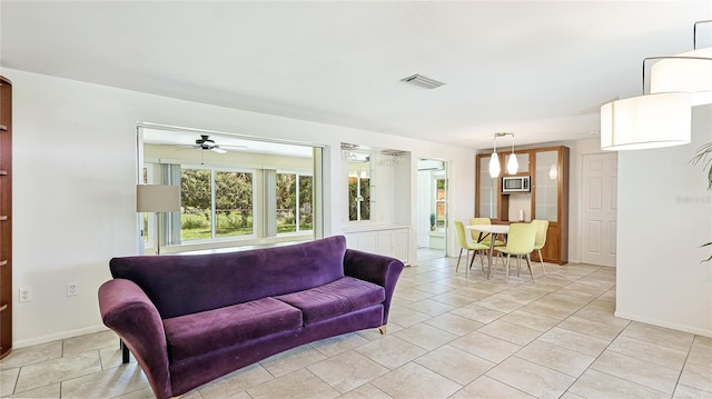 6529 Seagate Ave, Sarasota, FL 34231 - living area featuring baseboards and ceiling fan