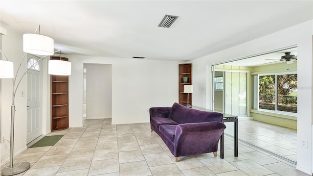 6529 Seagate Ave, Sarasota, FL 34231 - living room with a ceiling fan, light tile patterned floors, and baseboards