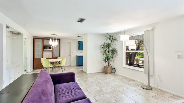 6529 Seagate Ave, Sarasota, FL 34231 - living room featuring light tile patterned floors and baseboards