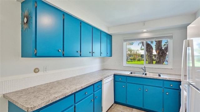 6529 Seagate Ave, Sarasota, FL 34231 - kitchen with a sink, white appliances, light countertops, and light tile patterned floors